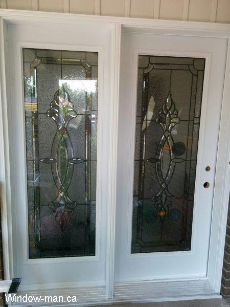 Patio French doors. White with extra wide sidelight. Looks like double. Center-Hinged French door. Only active side can be opened. Stained glass. installed